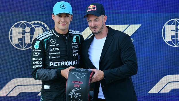 George Russell bekam von Dominik Paris die  Trophäe überreicht. © AFP / ANDREJ ISAKOVIC