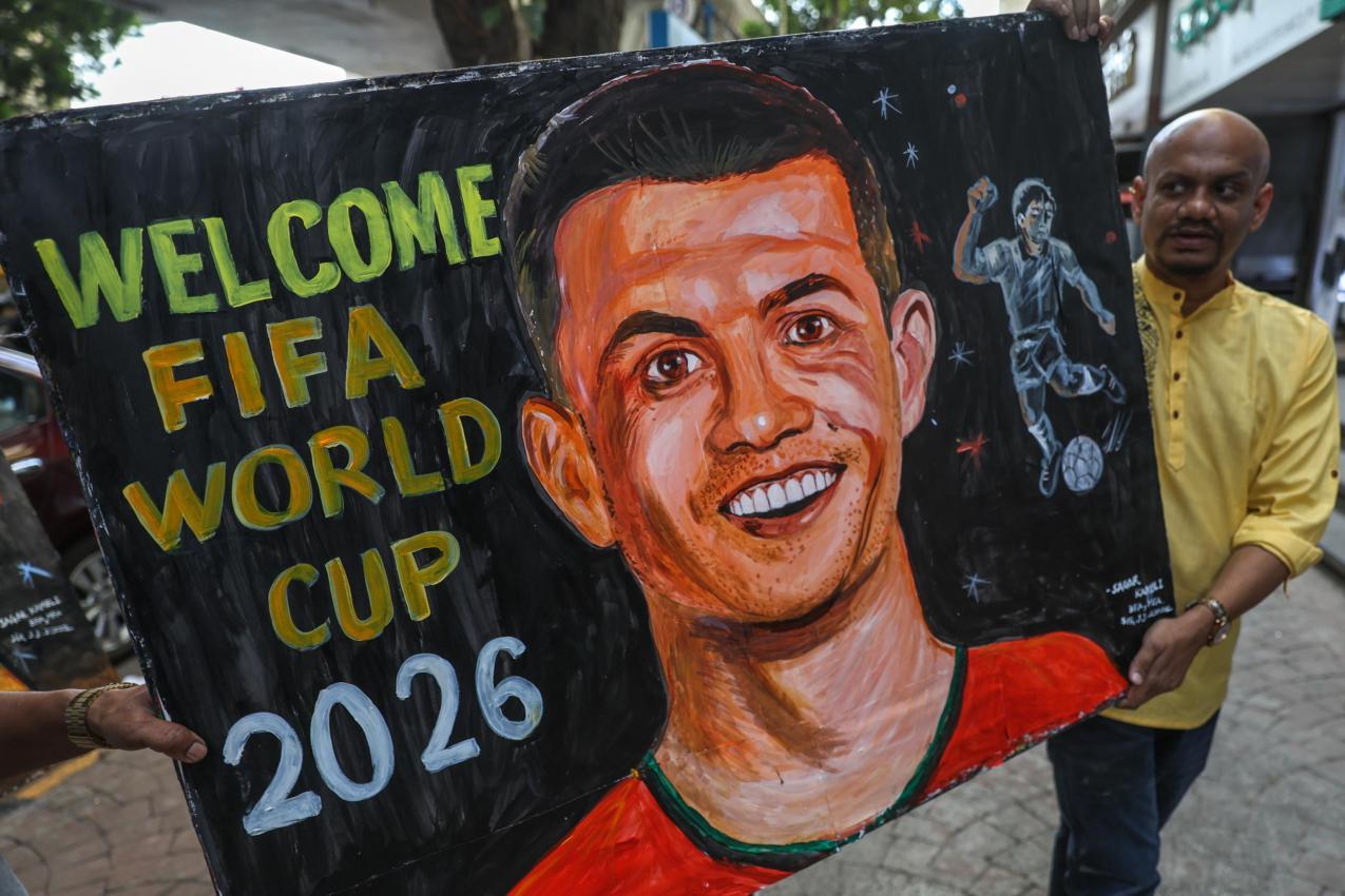 Stolz präsentiert ein Künstler sein Ronaldo-Werk zur WM 2026. © ANSA / DIVYAKANT SOLANKI